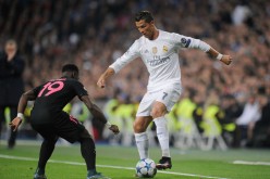 Real Madrid forward Cristiano Ronaldo (R) makes a move against a Paris Saint-Germain defender.