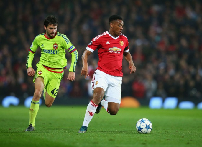 Manchester United striker Anthony Martial (R) dribbles past a CSKA Moscow defender.