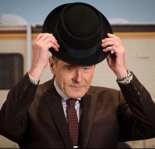 Bryan Cranston tries on Heisenberg hat from "Breaking Bad" TV series before turning it over along with other memorabilia to the Smithsonian Museum of American History.
