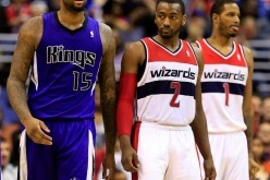Kings center DeMarcus Cousins (L) with Wizards' John Wall (#2) and Trevor Ariza during a regular season game.