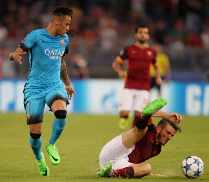 Barcelona winger Neymar (L) looks down at a fallen Alessandro Florenzi of Roma.