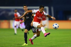 Arsenal winger Alexis Sanchez (R) dribbles past Dinamo Zagreb's Leonardo Sigali.
