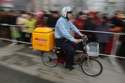 A delivery guy rides his bicycle in Nanjing, Jiangsu Province, on Jan. 18, 2007.