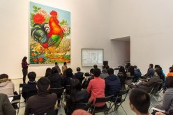Visitors attending the opening gala watch a video presentation. Lu Shengzhong (in front, middle) joins them.
