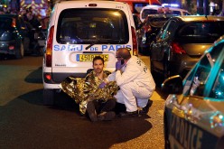 A medic tends to a man near the Boulevard des Filles-du-Calvaire after an attack in Paris, France, on Nov. 13, 2015.