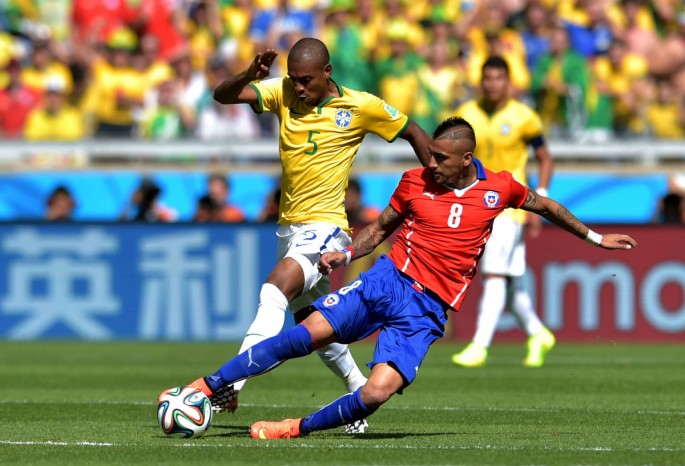 Chile midfielder Arturo Vidal competes for the ball against Brazil's Fernandinho in this file photo.