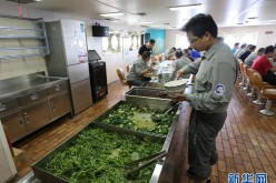 Team members have a meal aboard the icebreaker Xuelong on Nov 8, 2015.