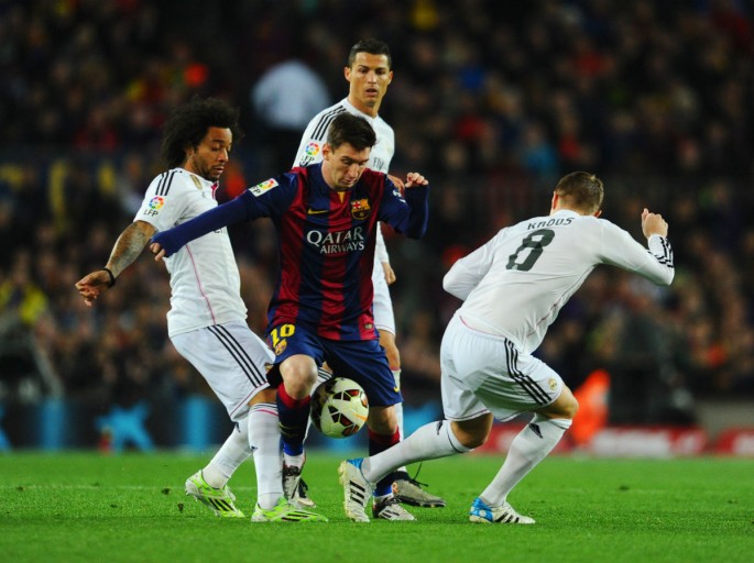 Barcelona's Lionel Messi takes on Real Madrid's Marcelo, Cristiano Ronaldo, and Toni Kroos during last March's El Clasico.