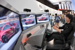 Tokyo Game Show In Tokyo, Japan On September 24, 2009 - A visitor controls a car in a driving game of ' XBOX 360' during Tokyo Game Show 2009 at Makuhari Messe in Chiba Pref.