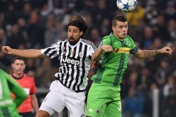 Borussia Monchengladbach midfielder Granit Xhaka competes for the ball against Juventus' Sami Khedira.