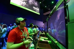 Gaming fans play Below from Xbox One at E3 - the Electronic Entertainment Expo - an annual video game conference and show at the Los Angeles Convention Center on June 16, 2015 in Los Angeles, California. 