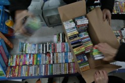 Chinese officials confiscate pirated DVDs during a raid on shops at Nanjing, Jiangsu Province, in this Jan. 17, 2007 photo.