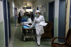 A nurse wheels a patient along a hospital hallway in Nanning, Guangxi Province, on Nov. 27, 2014.