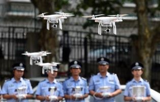 Law enforcers try to control and fly drones in Shenzhen.