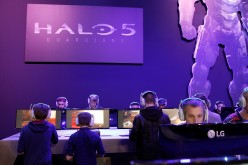 Visitors play a video game 'Halo 5 guardians' at the Paris Game Week, a trade fair for video games on October 28, 2015 in Paris, France. Paris Game week will run from October 28 until November 1, 2015. 