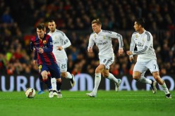 FC Barcelona forward Lionel Messi dribbles past Real Madrid's Jese, Toni Kroos, and Cristiano Ronaldo during last March's El Clásico.