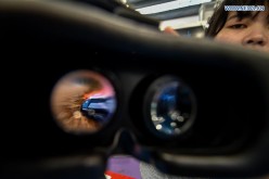 An exhibitor shows a virtual reality racing game at the 17th China Hi-tech Fair in Shenzhen, South China's Guangdong Province, Nov. 19, 2015.