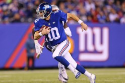 New York Giants quarterback Eli Manning rushes the ball against the New England Patriots.