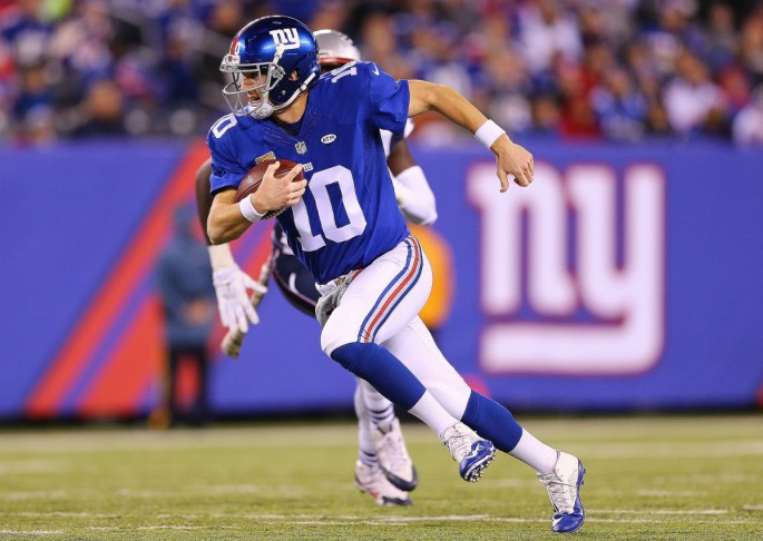 New York Giants quarterback Eli Manning rushes the ball against the New England Patriots.