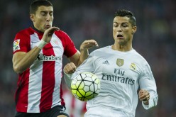 Athletic Bilbao's Oscar De Marcos competes for the ball against Real Madrid's Cristiano Ronaldo.