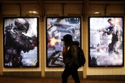 A woman walks past an advertisement of a new video game 'Call of Duty: Black Ops III' in New York on November 19, 2015.