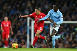 Liverpool winger Philippe Coutinho (L) competes for the ball against Manchester City's Bacary Sagna.