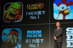 Billionaire Masayoshi Son, chairman and chief executive officer of SoftBank Corp., speaks in front of mobile game images of Clash of Clans and Boom Beach by gamemaker Supercell Oy during a news conference in Tokyo, Japan, on Friday, Aug. 8, 2014. 