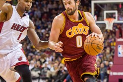 Kevin Love drives against Chris Bosh of the Miami Heat