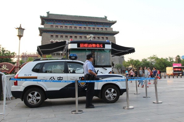 An armed police officer stands guard at Qianmen in Beijing on May 12, 2014.