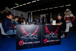 Gamers play the video game 'Assassin's Creed Syndicate' developed by Ubisoft on PlayStation games consoles PS4 at Paris Games Week, a trade fair for video games on October 29, 2015 in Paris, France. 