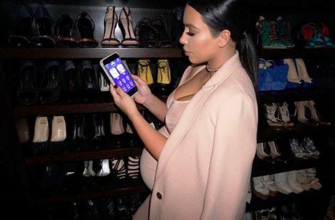 Kim Kardashian promoting her #secretclosetnet app.