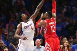 Los Angeles Clippers' De Andre Jordan (L) blocks Houston Rockets' Dwight Howard.