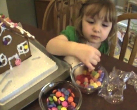 A kid takes multicolored candies, unaware of the dangers of artificial dyes poured in such foodstuff.