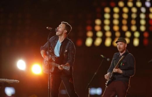 Chris Martin (L) performs with his band Coldplay in the Olympic Stadium during the closing ceremony of the London 2012 Paralympic... 