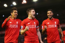 Liverpool midfielder James Milner (C) celebrates his goal with Roberto Firmino (L) and Emre Can.
