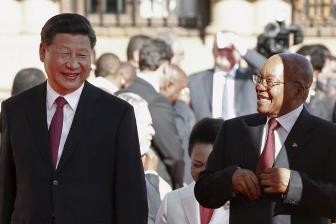 President Xi Jinping is welcomed by South African President Jacob Zuma upon his arrival at the Union Buildings in Pretoria.