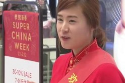 A clerk at a South Korean store tries to attract Chinese tourists who travel to the country to shop. 