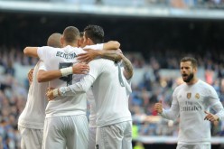 Real Madrid players celebrate Karim Benzema's opening goal against Getafe.