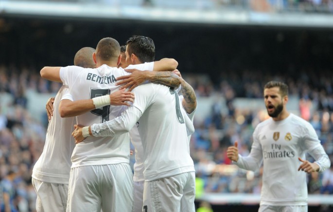 Real Madrid players celebrate Karim Benzema's opening goal against Getafe.