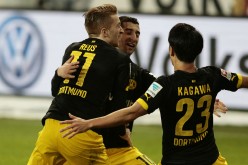 Borussia Dortmund winger Marco Reus (L) celebrates his opening goal against Wolfsburg with teammates Henrikh Mkhitaryan and Shinji Kagawa.