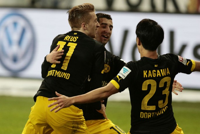 Borussia Dortmund winger Marco Reus (L) celebrates his opening goal against Wolfsburg with teammates Henrikh Mkhitaryan and Shinji Kagawa.