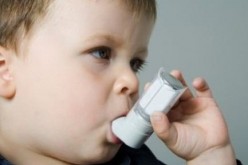 A child uses an asthma inhaler.