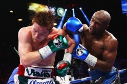 Floyd Mayweather Jr. throws a right to Canelo Alvarez during their WBC/WBA 154-pound title fight at the MGM Grand Garden Arena on September 14, 2013 