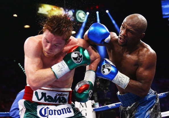 Floyd Mayweather Jr. throws a right to Canelo Alvarez during their WBC/WBA 154-pound title fight at the MGM Grand Garden Arena on September 14, 2013 