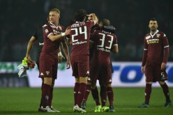 Torino players celebrate their draw with Roma.