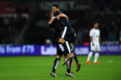 Leicester City winger Riyad Mahrez is lifted by teammate Danny Drinkwater after scoring a hat trick against Swansea City.