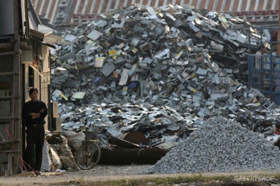Piles of electronic waste head up in front of the houses in Guiyu.