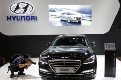 A visitor takes picture of Hyundai Genesis model during the Imported Auto Expo in Beijing.