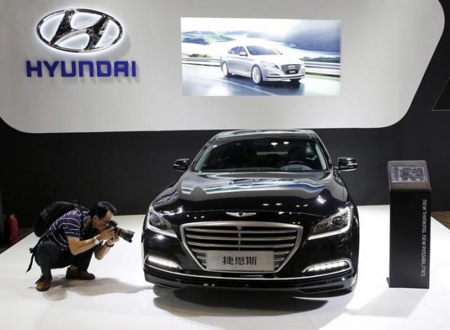 A visitor takes picture of Hyundai Genesis model during the Imported Auto Expo in Beijing.