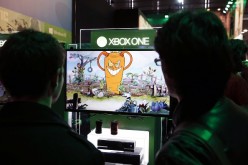 A visitor plays a game on a XBox One on October 28, 2015 at the Paris Game Week, a trade fair for video games in Paris. Paris Game week will run from October 28 until November 1, 2015. 